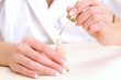Female hands with brush and enamel bottle Female hands with brush and enamel bottle