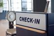 check-in sign at the airport with weights