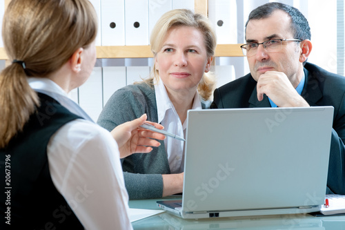 Photo: mid-adult couple meeting with financial planner mid-adult couple meeting with financial planner