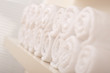 Line of rolled up white bath towels