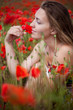 girl sitting in a field of poppies