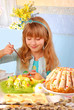young girl  painting easter eggs