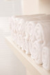 Line of rolled up white bath towels