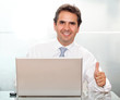 Business man with laptop and thumbs up