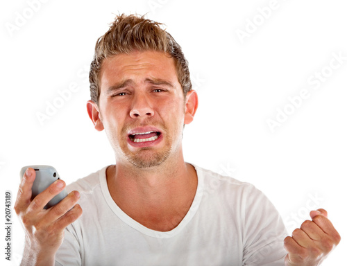 Photo: Man with a cell phone crying Man with a cell phone crying