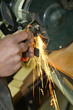 Grinding, close up of workers hand and sparks