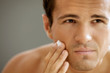 Close-up of young man applying shaving cream