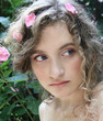 Portrait of a beautiful girl with flowers petals in her hair