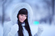 Portrait of beautiful young woman in winter park