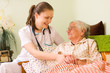 Foto: Helping a sick elderly woman Helping a sick elderly woman