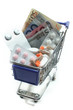Einkaufswagen mit Tabletten und Geld
