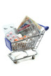 Einkaufswagen mit Tabletten und Geld