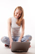 red-haired girl with laptop on white