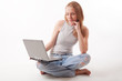 red-haired girl with laptop on white