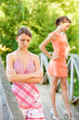 Two young and beautiful girls at banisters