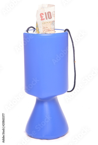 Photo: charity collection tin with money charity collection tin with money