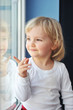 girl sits at window girl sits at window