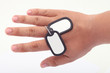 dog tag on the hand and white background