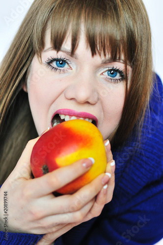 Photo: young woman eating apple young woman eating apple