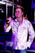 Young adult at a nightclub singing karaoke