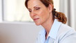 Confident mature lady working at her office