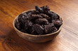 bowl of prune on wood table bowl of prune on wood table