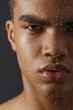 Face of man with water drops