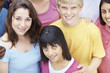 Young teenagers standing in a group and smiling