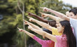 Multi racial teenagers pointing at copyspace outdoors