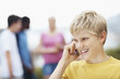 Closeup of teenager talking on cellphone against white