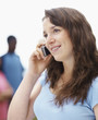 Closeup of teenager talking on a cellphone against white