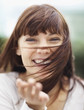 Happy attractive brunette with windblown hair