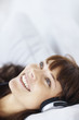 Closeup of a female listening to music on headphones