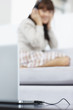 Blur image of a woman listening to music on the laptop