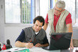 Hommes au bureau devant un ordinateur portable avec documents