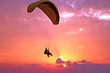 Flight of paraplane above Mediterranean sea on sunset