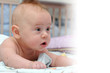 Happy baby crawling in bed