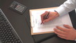 business man is working on a check-list in the office business man is working on a check-list in the office