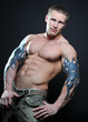 Muscled male model posing in studio