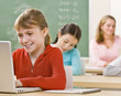 Student using laptop in classroom