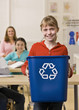 Girl holding recycling bin