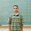 Student standing near blackboard