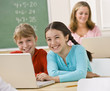 Girls using laptop in classroom
