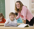 Teacher helping student in classroom
