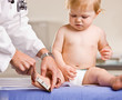 Doctor giving baby girl checkup in doctor office