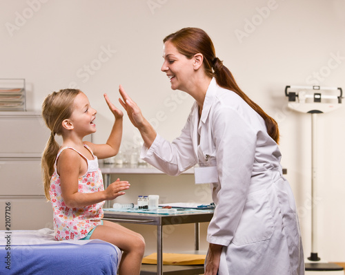 Photo: Doctor giving girl high-five Doctor giving girl high-five