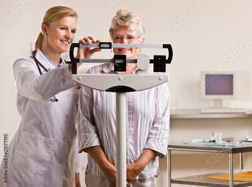 Photo: Doctor weighing senior woman in doctor office Doctor weighing senior woman in doctor office