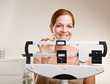 Woman weighing herself in doctor office