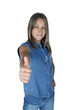 Portrait of young girl giving thumbs up, studio shot