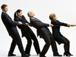 Photo: Business people playing tug-of-war Business people playing tug-of-war